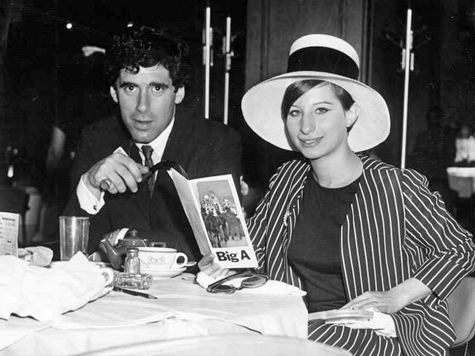 Elliott Gould and Streisand at restaurant table