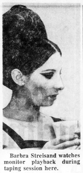 Streisand watches monitor playback during taping session here